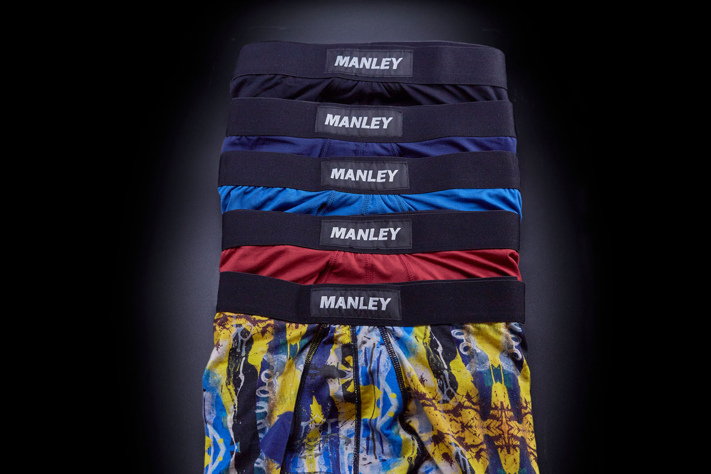 Multi-coloured boxer briefs with Manley Barrier Technology that stops the pee spot. Feel manly in Manley. Five pairs of Manley boxer briefs overlapping each other, showing/contrasting the different colours available