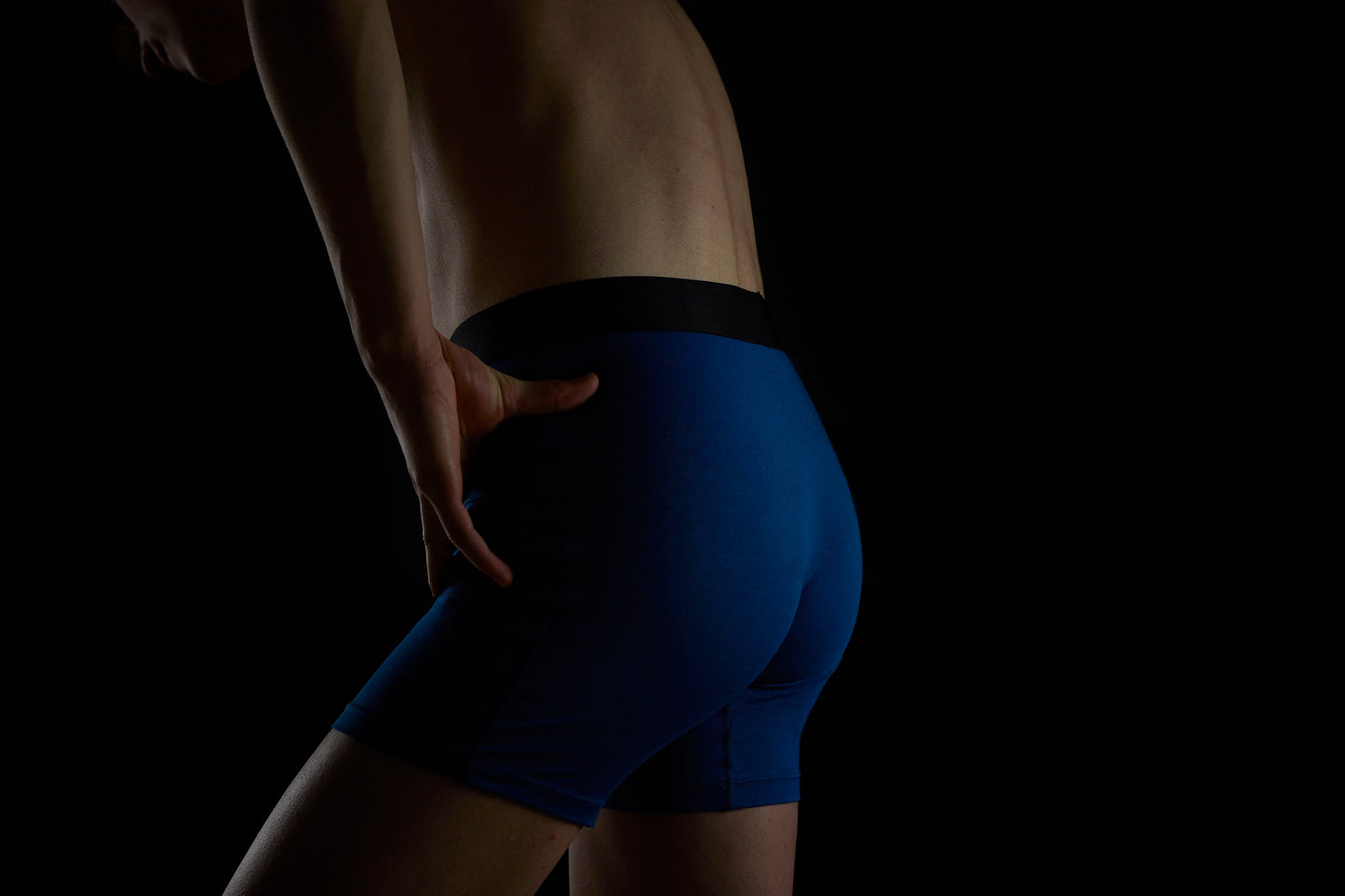 Eclectic Blue boxer briefs with Manley Barrier Technology that stops the pee spot. Feel manly in Manley. Model wearing Eclectic Blue boxer briefs, side/back view