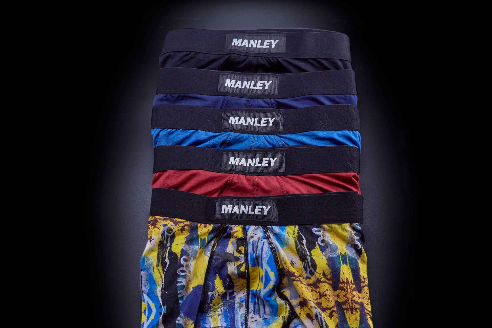 Multi-coloured boxer briefs with Manley Barrier Technology that stops the pee spot. Feel manly in Manley. Five pairs of Manley boxer briefs overlapping each other, showing/contrasting the different colours available