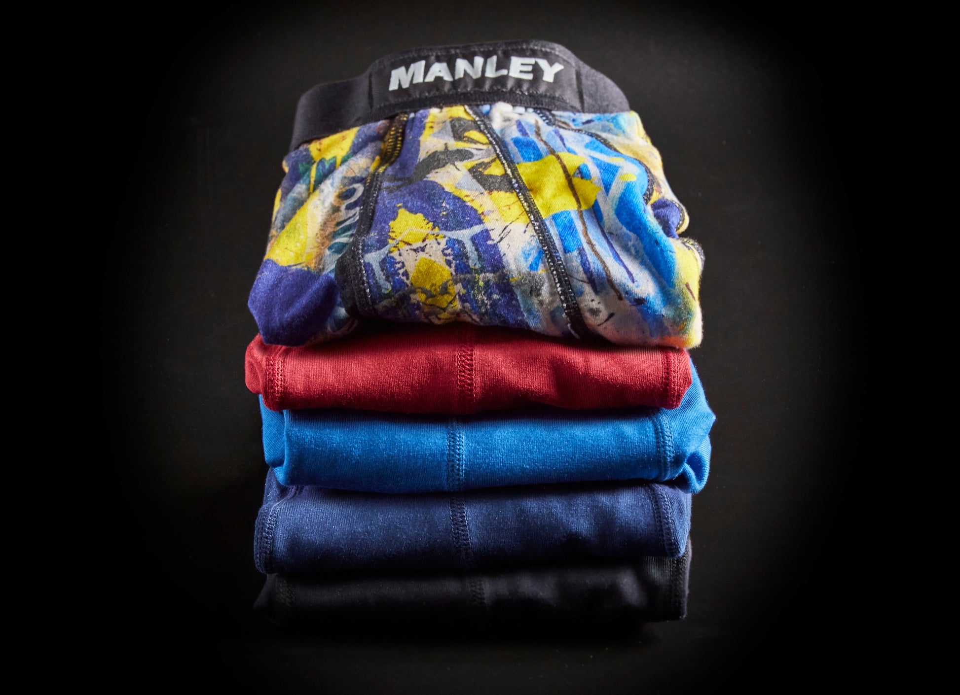 Stack of five pairs of Manley Barrier Underwear showing the different colours available. Manley Barrier Technology that stops the pee spot. Feel manly in Manley. Stop the Pee Spot.  
