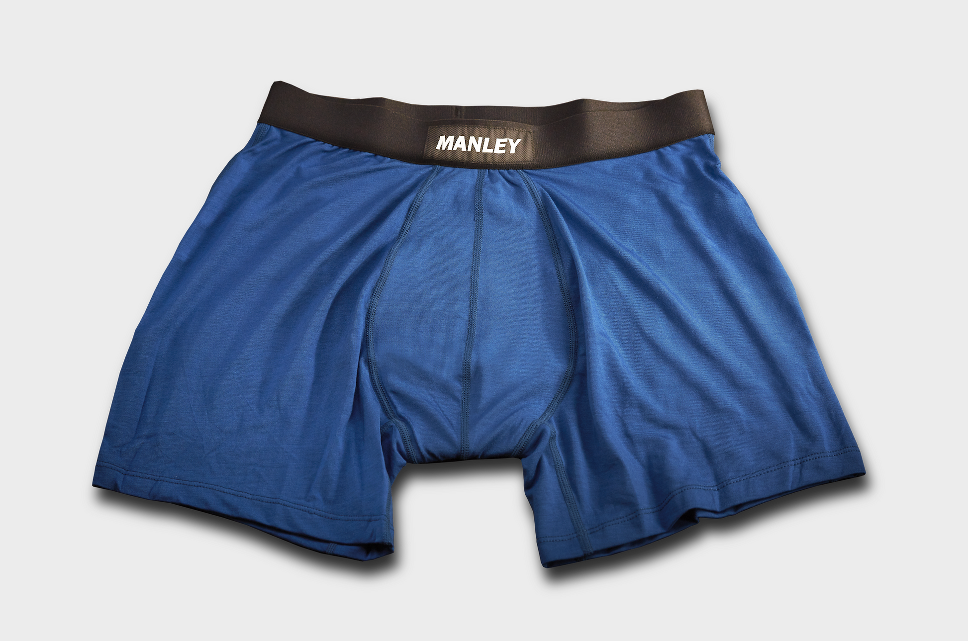 Black boxer briefs with Manley Barrier Technology that stops the pee spot. Feel manly in Manley. Eclectic blue boxer briefs photo, showing the Manley logo on the waistband 