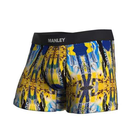 Manley Hello! Yellow boxer briefs, designed by artist Anthony Ricciardi, abstract design in blue, yellow, black, and white. Manley Barrier Technology that stops the pee spot. Feel manly in Manley.Stop the Pee Spot. 
